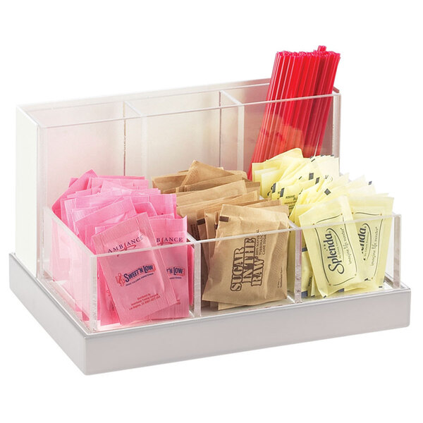 A Cal-Mil multi-bin condiment organizer with a stainless steel base holding condiments and sugar packets.