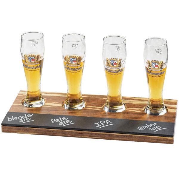 A row of 4 beer glasses on a Cal-Mil Crushed Bamboo flight tray.