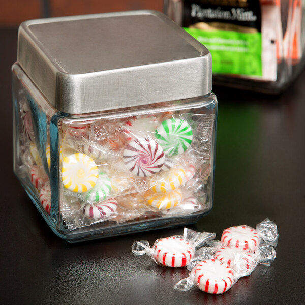 An Anchor Hocking glass jar filled with candy on a table.