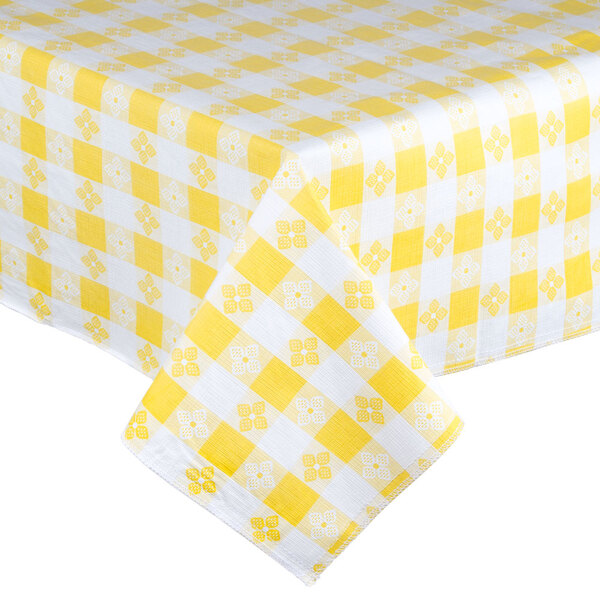 A yellow and white checkered Intedge vinyl table cover on a table.