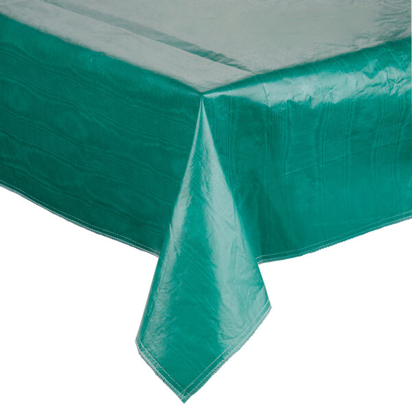 A green Intedge vinyl table cover with flannel back on a large square table.