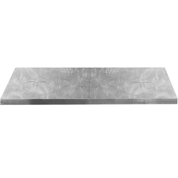 A silver rectangular metal cover with a random swirl pattern on it.