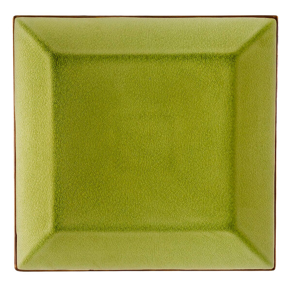 A square green plate with brown edges.