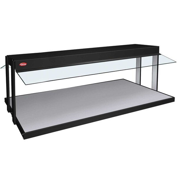 A black Hatco buffet warmer on a white shelf with glass top.