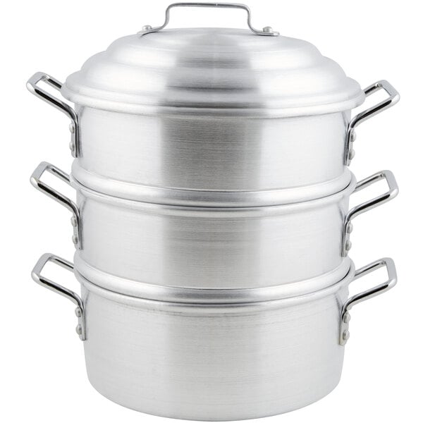 A stack of silver aluminum steamer pots.