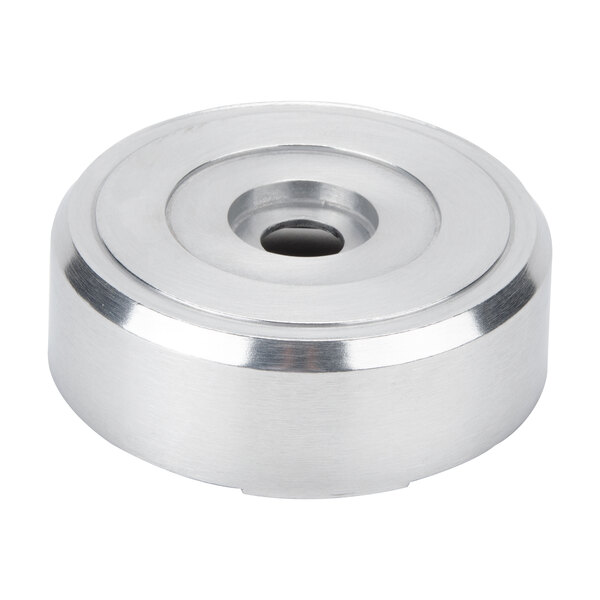 A stainless steel round blender base with a hole in the middle.