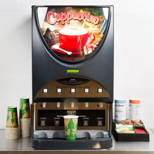 A Bunn powdered cappuccino dispenser on a counter with a red cup underneath.