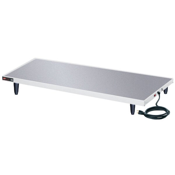 A white rectangular Hatco heated shelf warmer on a white table.