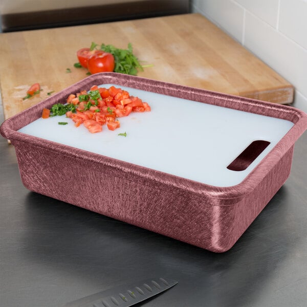 A raspberry deep tote and cutting board with chopped tomatoes in a container.
