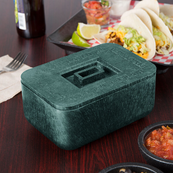 A rectangular HS Inc. jalapeno container with a square lid on a table with food including salsa and tacos.