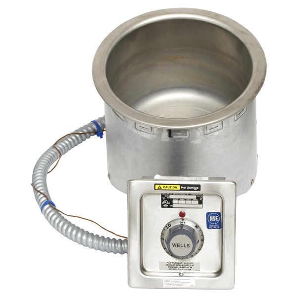 A Wells round insulated drop in soup well with a stainless steel top and a heater.