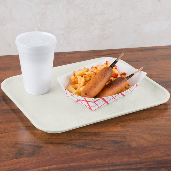A Carlisle white Glasteel tray with food and a drink on it.