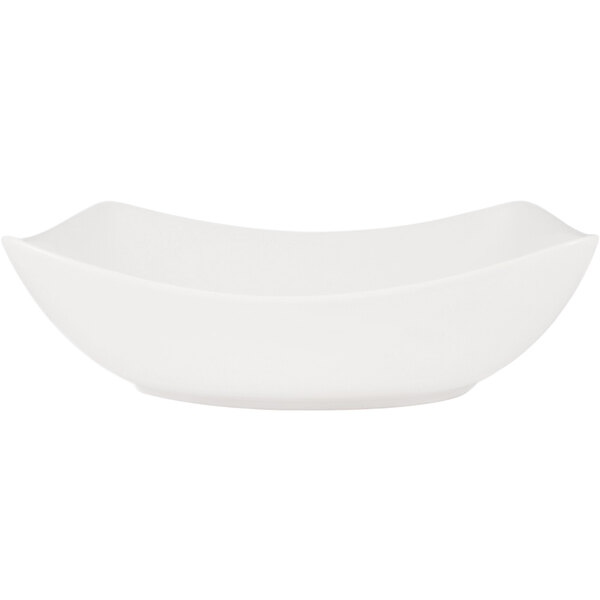 A CAC Bright White rectangular porcelain bowl with a curved edge.