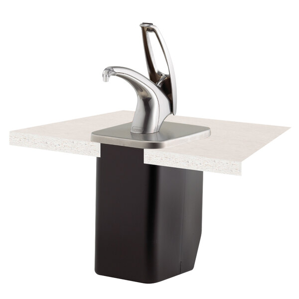 A San Jamar FrontLine universal in-counter metal condiment dispenser system on a counter with a metal faucet.