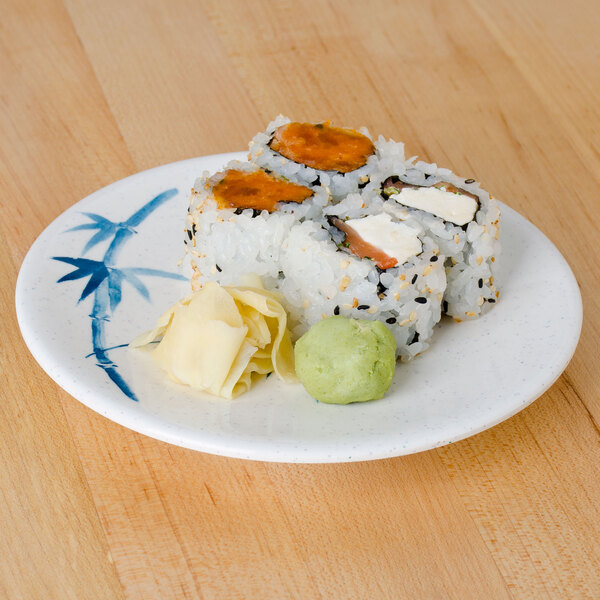 A Thunder Group Blue Bamboo melamine plate with a sushi roll on it.