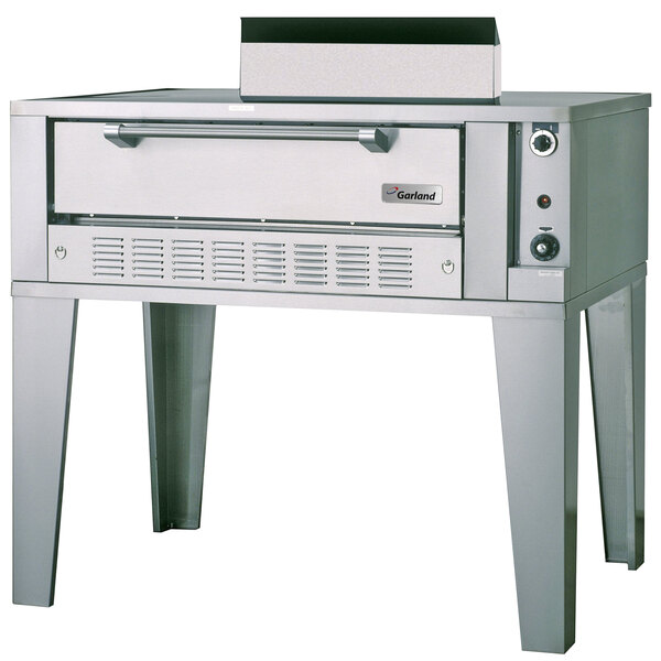 A large stainless steel Garland pizza oven with a metal top.
