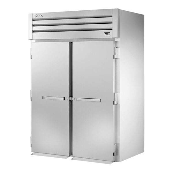 A large white True Spec Series roll-in refrigerator with two doors.