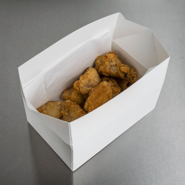 A white Take Out Lunch box filled with fried chicken.