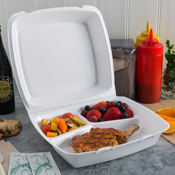 A white Dart foam container with 3 compartments filled with food.