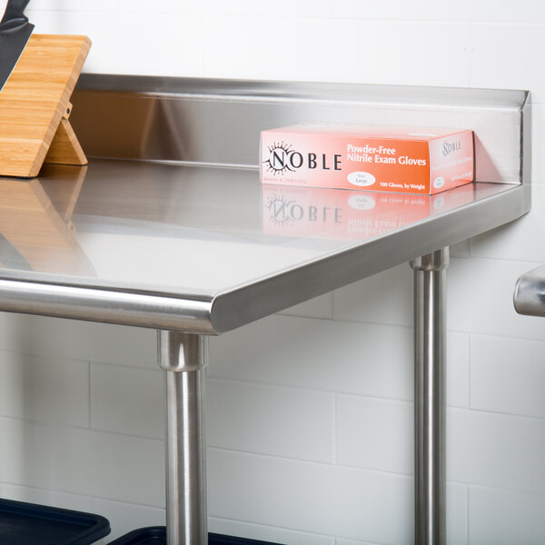 A box on an Advance Tabco stainless steel work table with undershelf.