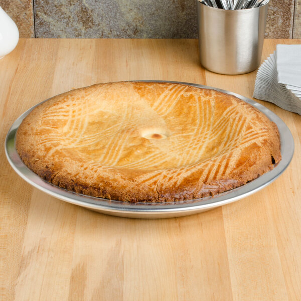 An American Metalcraft aluminum pie in a metal pie pan on a table.