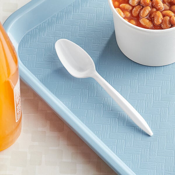 A blue tray with a white container of beans and a white plastic teaspoon.