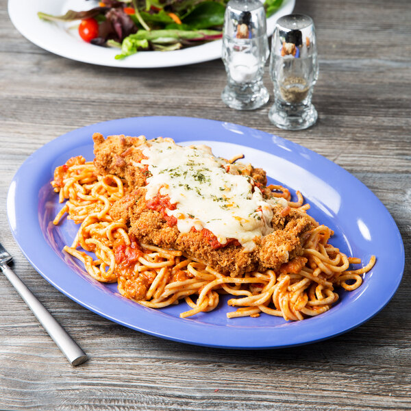 A GET Mardi Gras melamine platter with a plate of spaghetti with meat sauce and cheese on it.