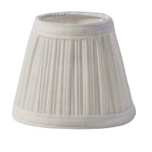 A close-up of a small ivory lamp shade with pleats.