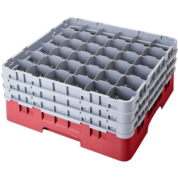 A red and gray plastic Cambro glass rack with many compartments and an extender.