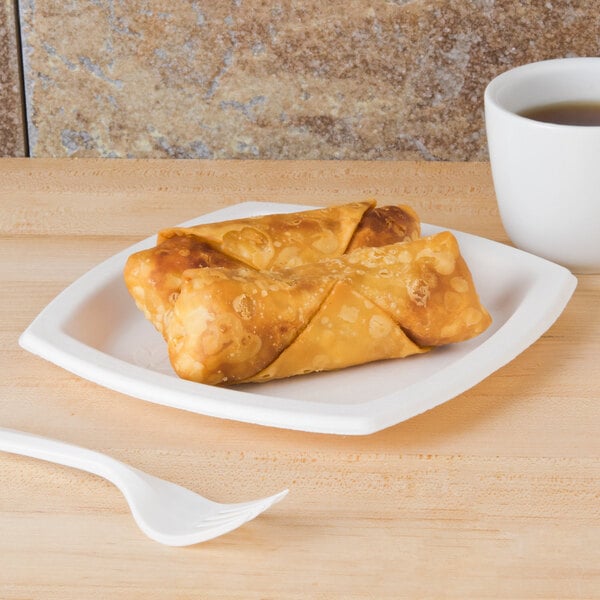 A Bare by Solo compostable sugarcane plate with fried egg rolls on it.