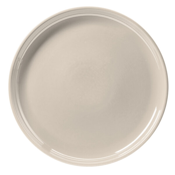 A white Hall China chop plate with a rim.