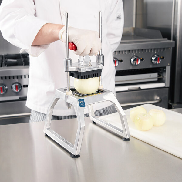 A chef using the Vollrath Redco InstaCut 3.5 to dice an onion.
