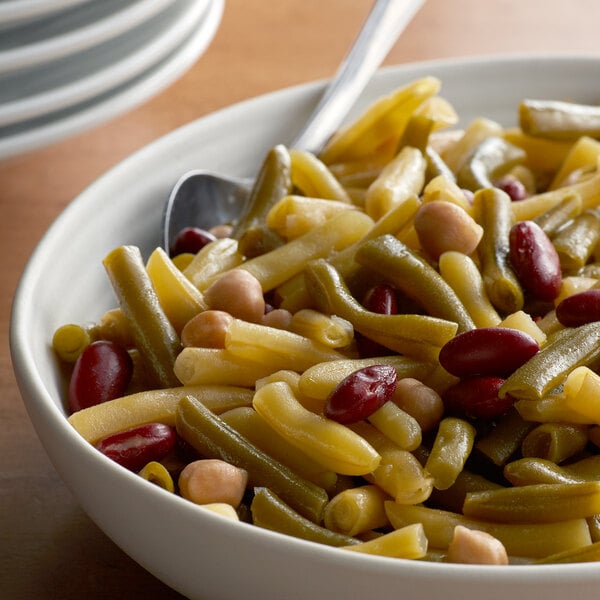 A bowl of Furmano's Four Bean Salad with a spoon in it.