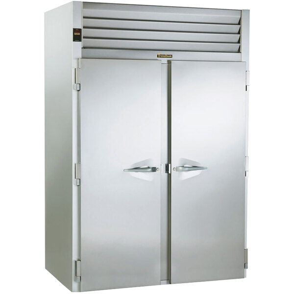 A large Traulsen stainless steel roll-in refrigerator with two open doors.