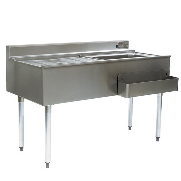 A stainless steel Eagle Group cocktail workstation with a right side ice bin on a stand with a sink and drawers.