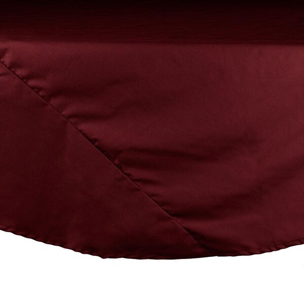 A close-up of a burgundy round Intedge table cover.