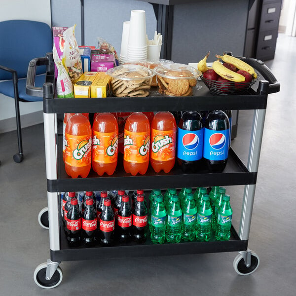 A black Cambro utility cart with shelves holding food and drinks.