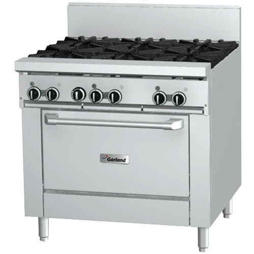 A stainless steel Garland commercial gas range with black knobs.