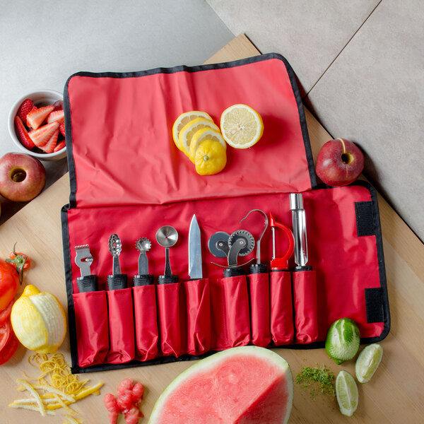A red Tablecraft bag with fruit and garnishing tools inside.