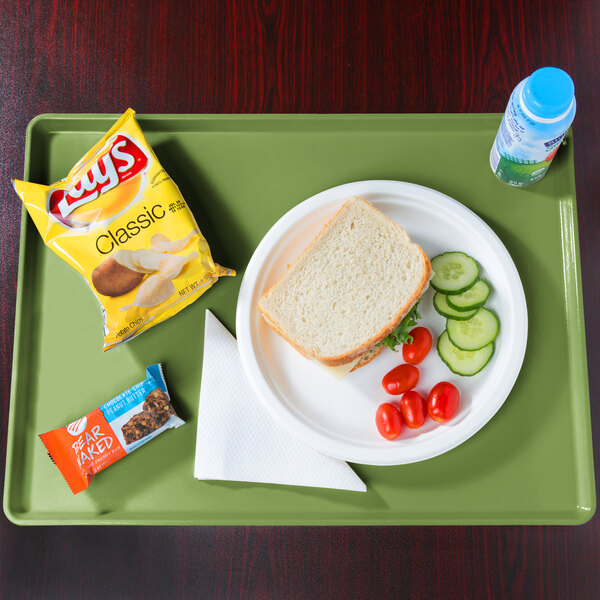 A Cambro lime-ade dietary tray with a sandwich and a drink on it.