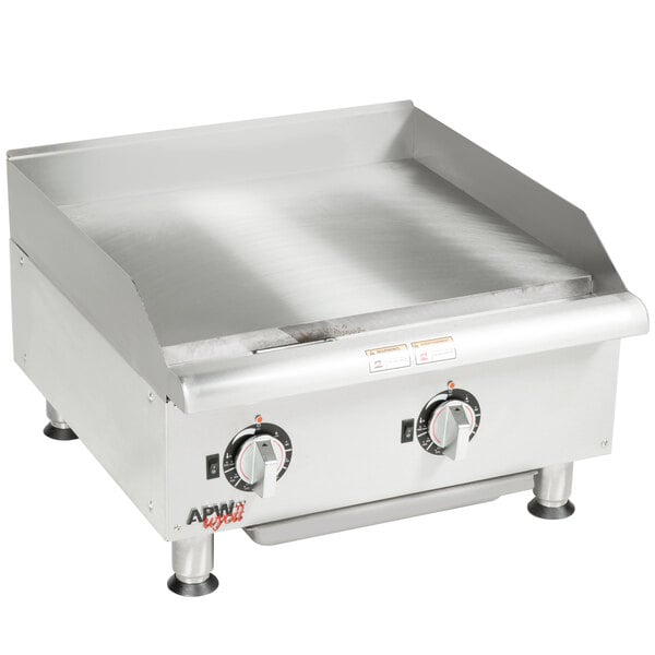 An APW Wyott stainless steel electric countertop griddle on a counter.