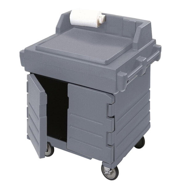 A grey Cambro food preparation cart with a roll of paper inside.