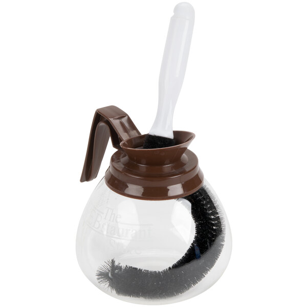 A Thunder Group coffee decanter cleaning brush inside a coffee decanter.