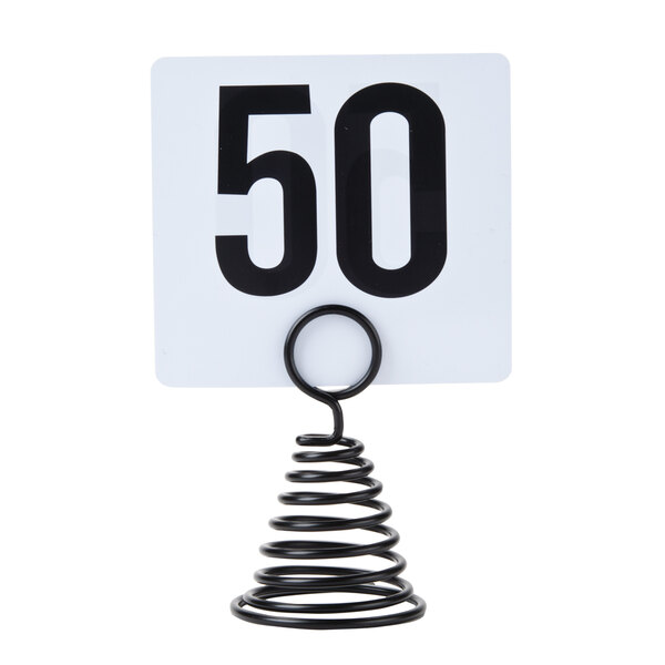 An American Metalcraft black spiral table number holder with a white card and black numbers on a black spring.