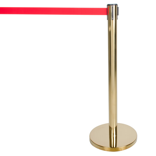 A gold pole with a red tape reel attached and a gold base.