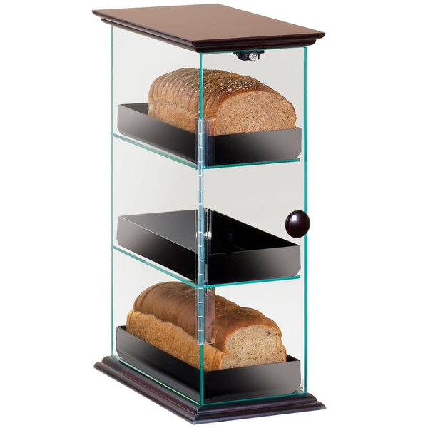 A Cal-Mil glass display case with bread on two shelves.