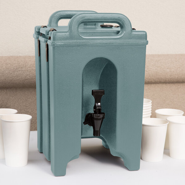 A blue Cambro insulated beverage dispenser with a black spigot on top.
