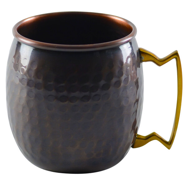 A 10 Strawberry Street hammered antique copper Moscow Mule mug with a handle.