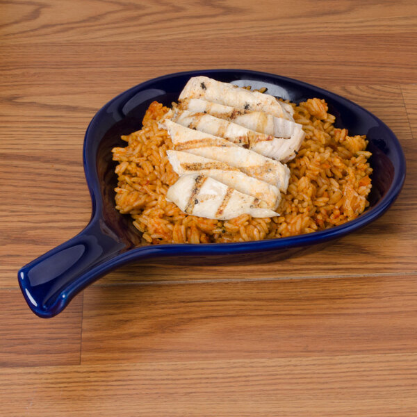A blue plate with rice and chicken on it.