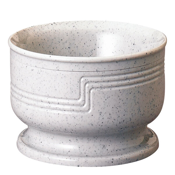 A white bowl with black speckled designs.